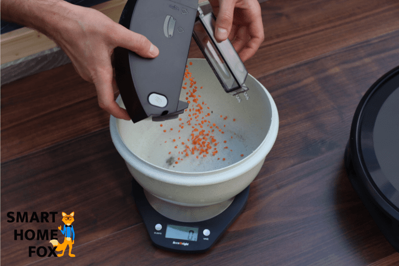 Mobiler Staubbeutel wird über dem Mülleimer ausgeleert.